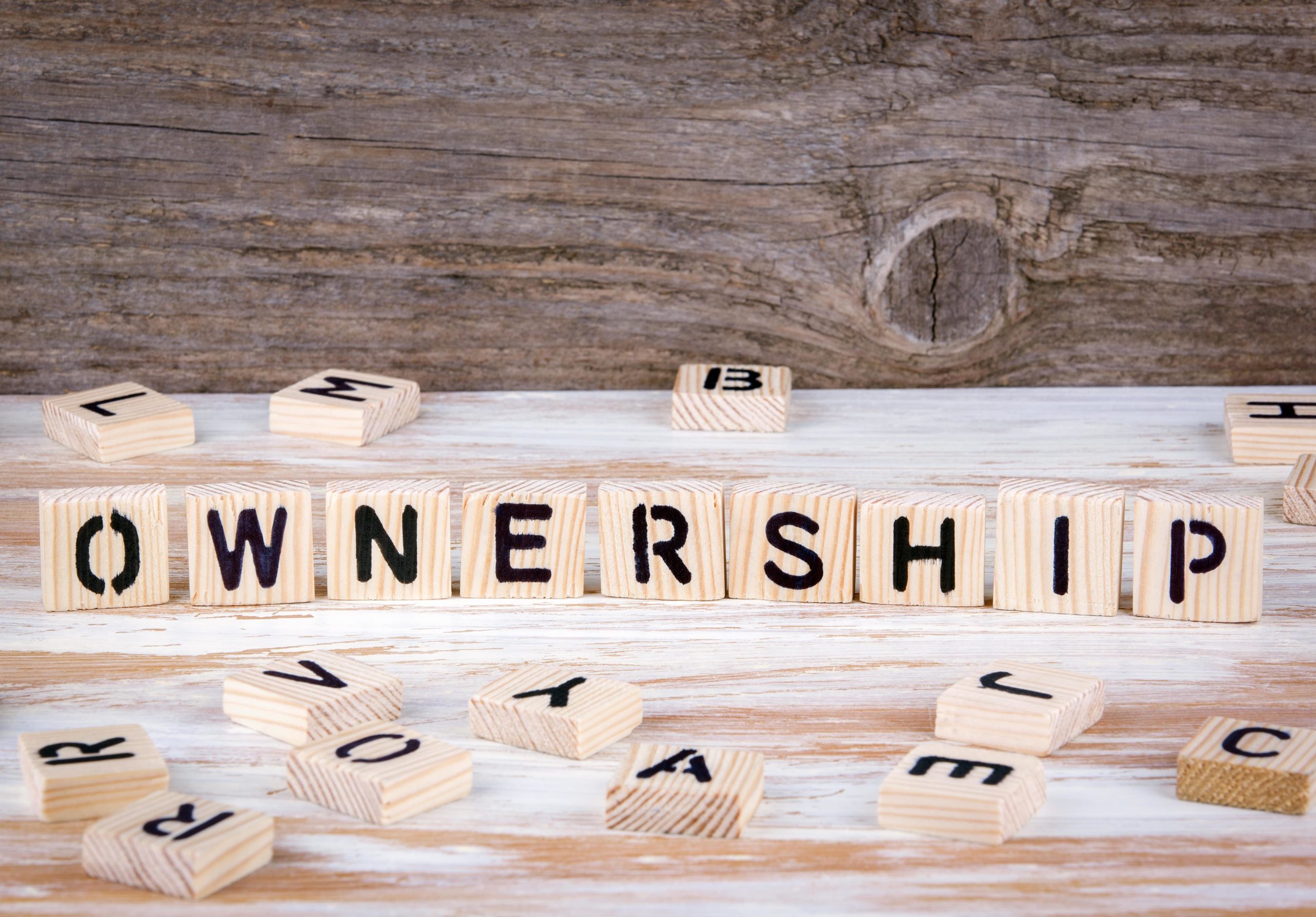 Scrabble blocks spelling out the word OWNERSHIP