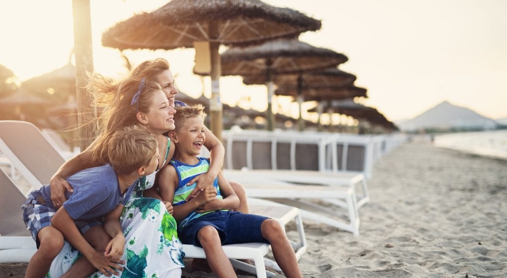 Mom and children smiling on beach