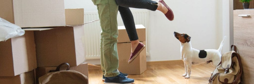 Man hugging woman and lifting her off the ground