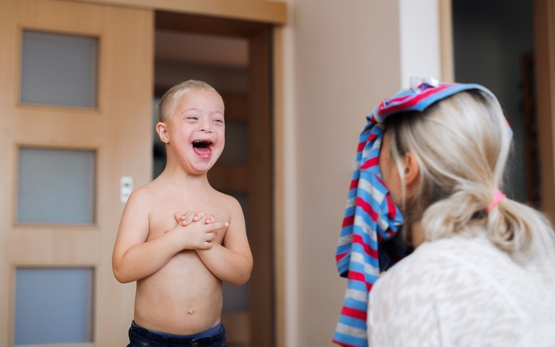 Boy smiling at mom on the steps of their house