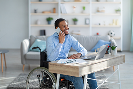 disabled man on phone call in home office