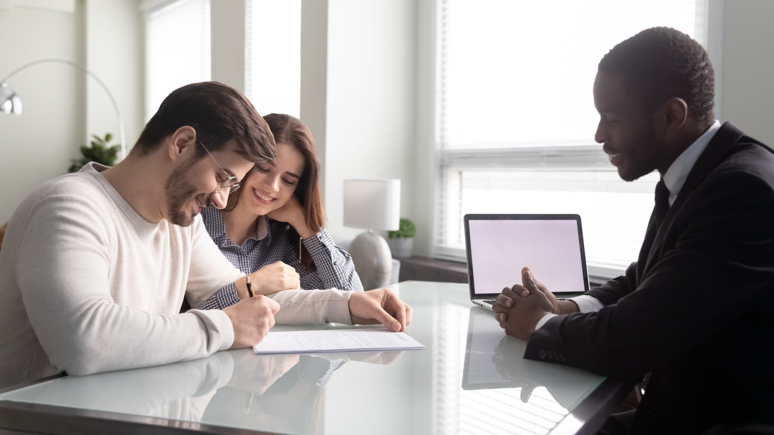 Couple signing document with lender