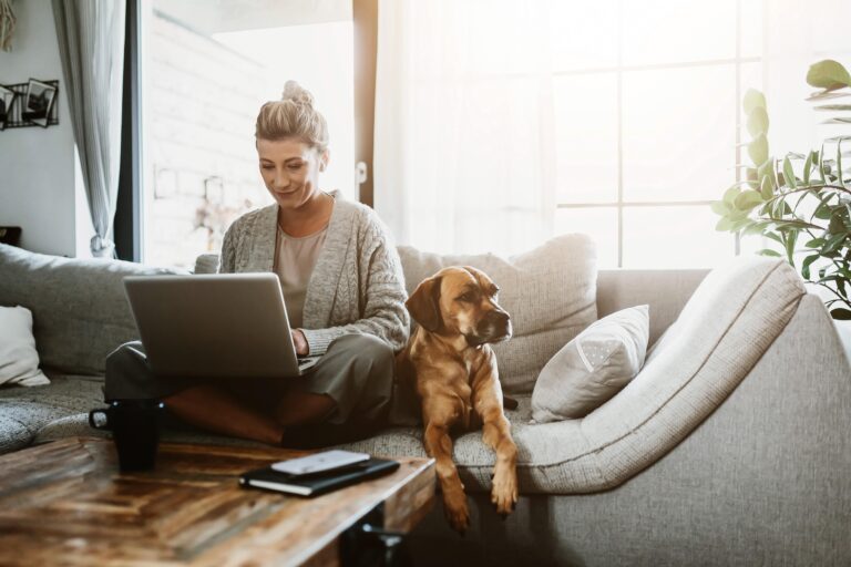 Lady sitting on couch with dog