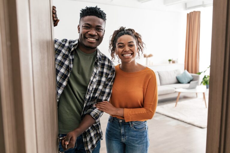 Couple smiling from inside house