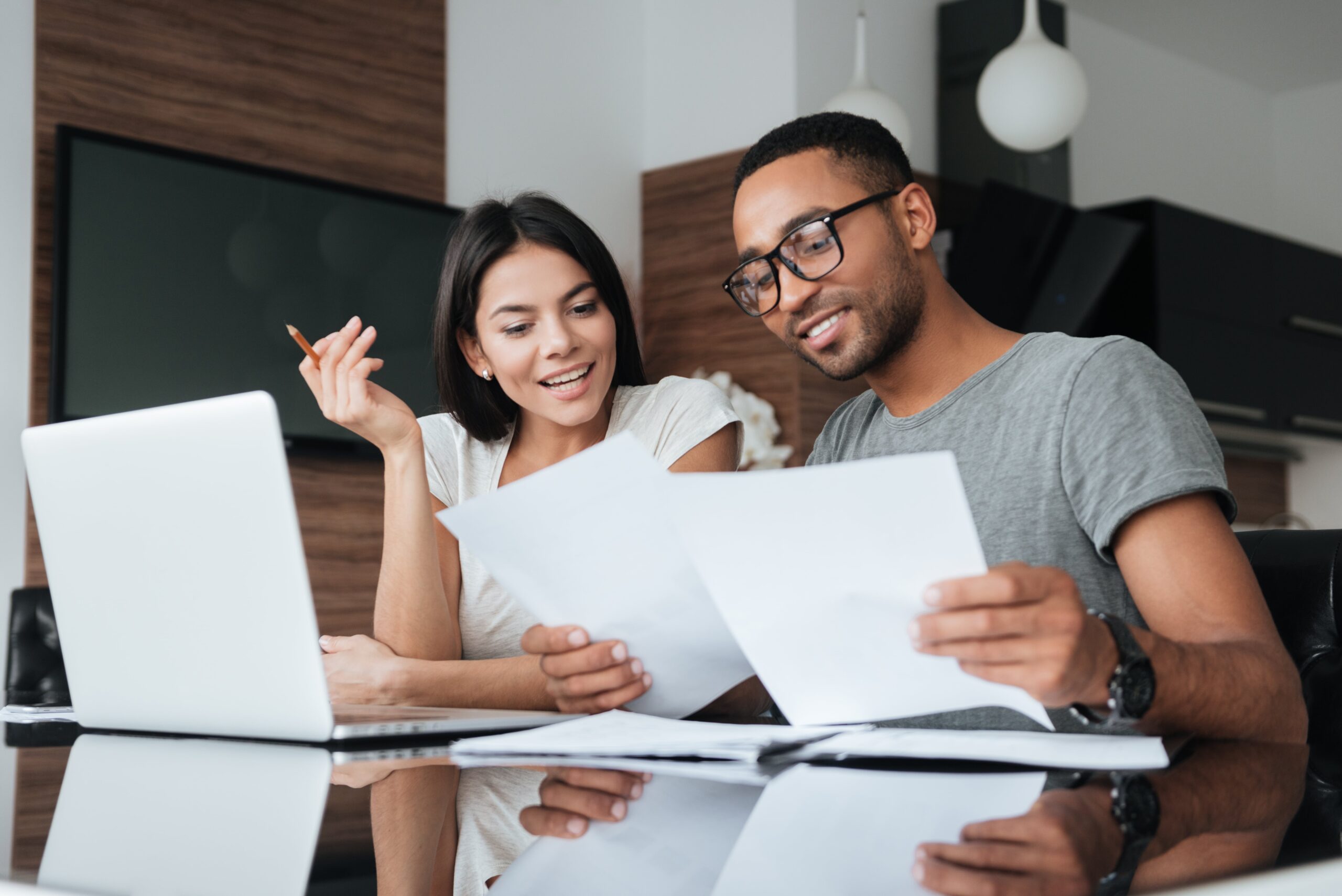 Couple looking at paperwork at home