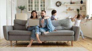 Couple sitting in living room on couch